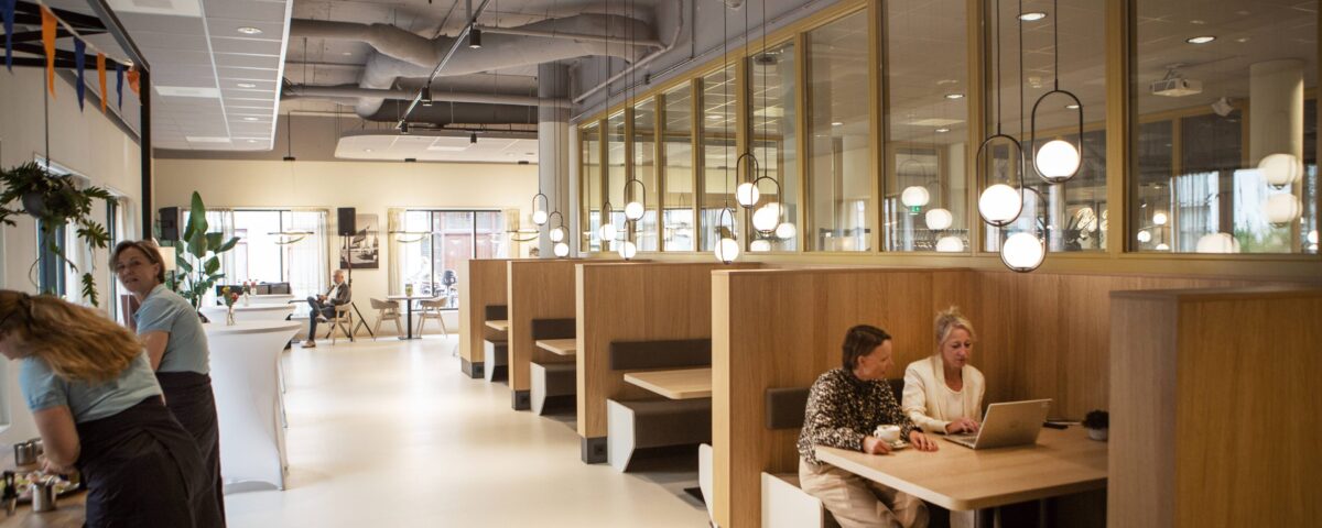 restaurant janskliniek met twee collega's aan tafel met laptop